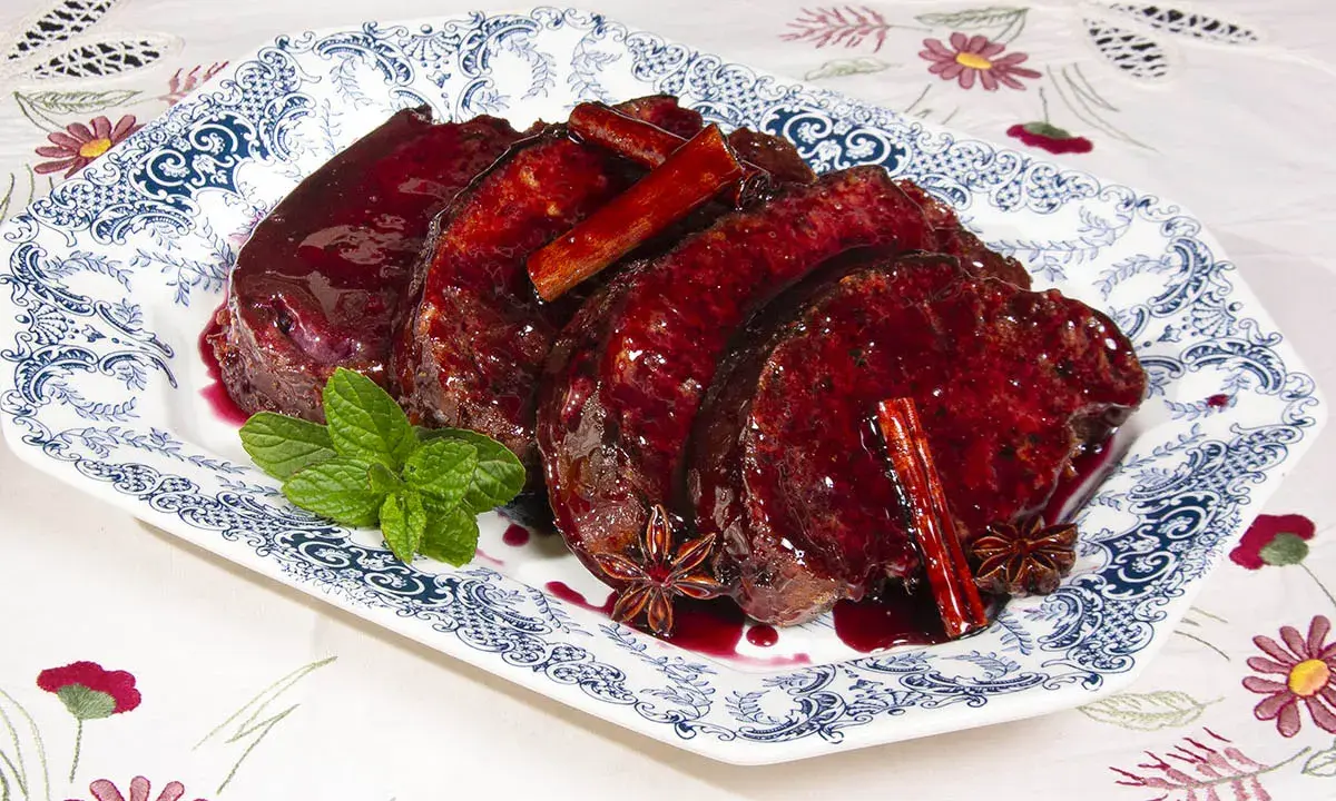 Rebanadas de torrijas de vino, bañadas en salsa de frutos rojos, con canela y anís estrellado. Decoradas con menta fresca.