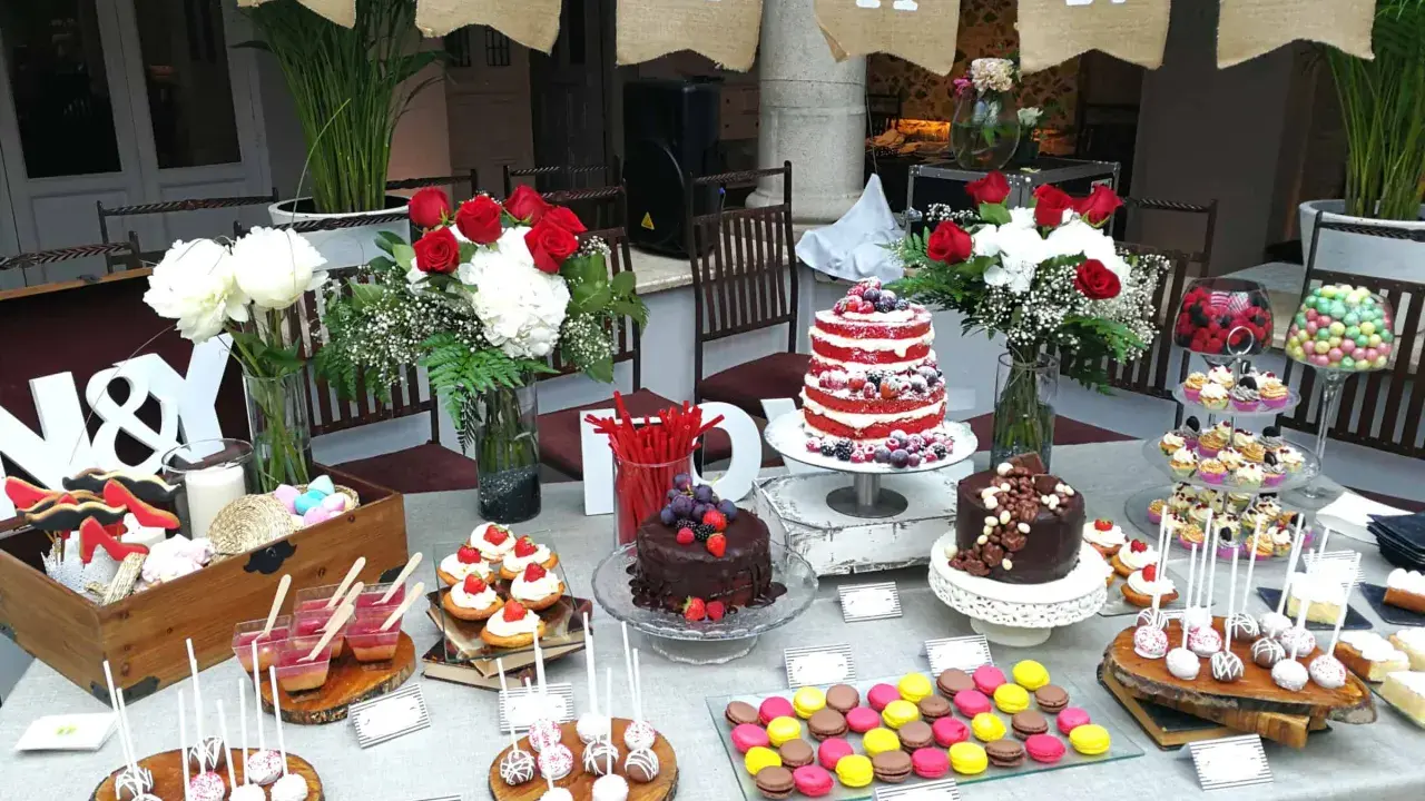 Una mesa dulce boda con pasteles, cupcakes, macarons y flores. ¡Un festín para los ojos y el paladar!