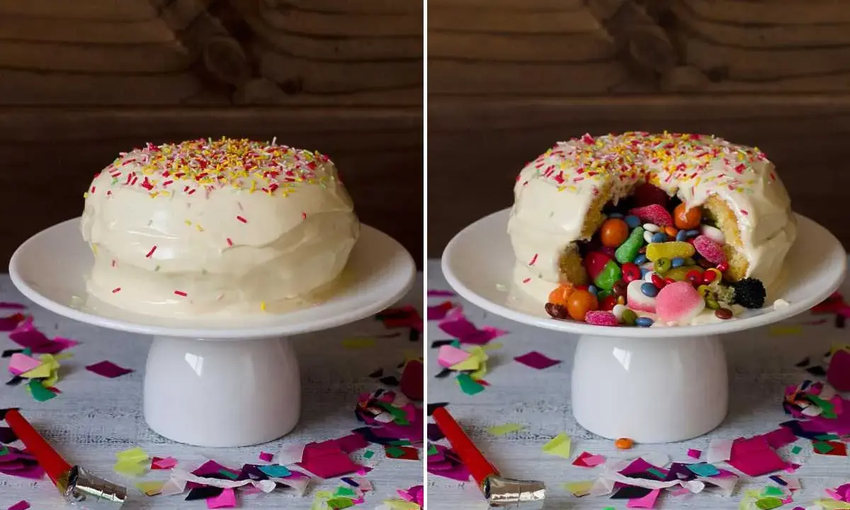 Tarta de gominolas sorpresa. Un pastel blanco cubierto de chispas de colores, que al cortarlo revela un interior lleno de dulces.