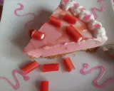 Deliciosa tarta de regaliz rojo con crema rosa y adornos de regaliz.