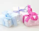 Cajas de regalo con lunares, envueltas en cintas rosas y azules. ¡Perfectas para ideas originales con chuches!