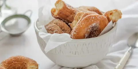 Roscos de Semana Santa azucarados en un cuenco blanco, listos para disfrutar.