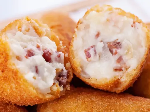 Croquetas cremosas con trocitos de jamón, listas para freír. Los ingredientes perfectos para unas croquetas caseras.