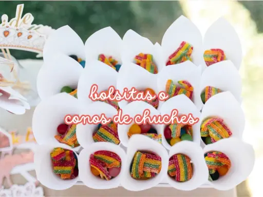 Conos blancos llenos de diferentes tipos de chuches, como gominolas arcoíris y bolitas de colores.
