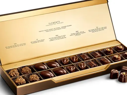 Caja abierta de chocolates finos, "la chuche más cara del mundo", con descripciones de sabores inspirados en elementos naturales.