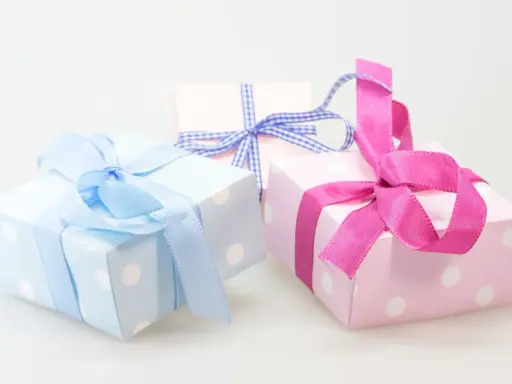 Cajas de regalo con lunares, envueltas en cintas rosas y azules. ¡Perfectas para ideas originales con chuches!
